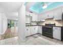 Bright kitchen with white cabinets, modern appliances, and a stylish backsplash, providing a clean and functional space at 820 Patricia Ave # 207, Dunedin, FL 34698