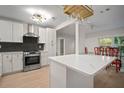 Modern kitchen with white cabinets, stainless steel appliances, and quartz countertops at 851 16Th S Ave, St Petersburg, FL 33701