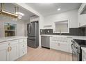 Stylish kitchen featuring white shaker cabinets, stainless steel appliances, and a farmhouse sink at 851 16Th S Ave, St Petersburg, FL 33701