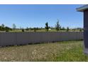 Fenced backyard with view of the undeveloped land behind the property at 10725 Tippecanoe Pl, Parrish, FL 34219