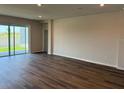 Spacious living room with hardwood floors and sliding glass doors to the backyard at 10725 Tippecanoe Pl, Parrish, FL 34219