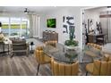 Bright dining area with a glass-top table and stylish seating at 11188 Livewell Ct, Venice, FL 34293