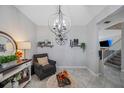 Sitting area with a chandelier and comfortable seating near a staircase at 11321 Chilly Water Ct, Riverview, FL 33569