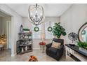 Bright sitting area with a large chandelier and comfortable seating at 11321 Chilly Water Ct, Riverview, FL 33569