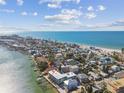 Stunning aerial view of the property with ocean, coastal community, and dock access at 143 94Th Ave # 2, Treasure Island, FL 33706