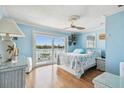 Charming main bedroom with en-suite bathroom, water view, and access to private balcony at 143 94Th Ave # 2, Treasure Island, FL 33706