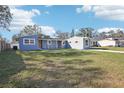 Newly renovated light blue house with a large yard at 2537 Martha Ln, Land O Lakes, FL 34639