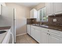 White kitchen with granite countertops and stainless steel appliances at 3206 W Azeele St # 100, Tampa, FL 33609