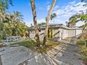 Backyard with patio, lush landscaping, and spacious seating area at 35 Juniper Way, Clearwater Beach, FL 33767