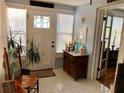 Bright and airy entryway with tiled floors and a vintage wooden console table at 512 79Th Ave, St Pete Beach, FL 33706