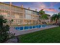 Beautiful condominium complex pool with a serene setting and well manicured lawn and landscaping at 637 Pinellas Bayway S # 207, Tierra Verde, FL 33715