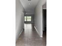 Bright hallway with tile floors and neutral-toned walls at 8517 Hunters Fork Loop, Ruskin, FL 33573