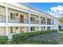Multi-Gathering exterior featuring white walls, black railings, and well-maintained landscaping at 2060 Marilyn St # 241, Clearwater, FL 33765