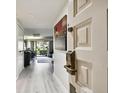 Bright entryway with light wood floors and view of living area at 36750 Us Highway 19 N # 01104, Palm Harbor, FL 34684
