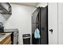 Black refrigerator in galley kitchen at 36750 Us Highway 19 N # 01104, Palm Harbor, FL 34684