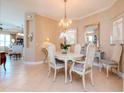 Bright dining room featuring a chandelier and elegant furniture at 5314 Golden Isles Dr, Apollo Beach, FL 33572