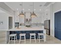 Beautiful kitchen with white cabinets, stainless steel appliances, and a large marble island at 5713 Tybee Island Dr, Apollo Beach, FL 33572