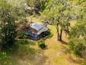 Aerial view of a home nestled among the trees on a large lot at 7313 Clayton Rd, Brooksville, FL 34601