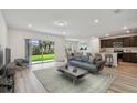 Bright living room featuring an open floor plan with a sliding glass door that leads to the backyard at 10524 Hidden Banks Gln, Parrish, FL 34219
