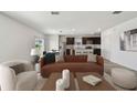 Open-concept living room with sleek hardwood floors and modern furnishings at 10541 Hidden Banks Gln, Parrish, FL 34219