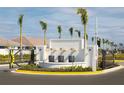 Gated entrance with water feature and palm trees at 12260 Meditation Trl, Venice, FL 34293