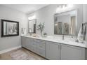 Luxurious bathroom with double vanity and large mirrors at 13430 Haflinger Way, Hudson, FL 34667