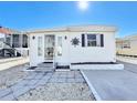 White mobile home with a sun design and small front yard at 162 S Saint Thomas Cir, Apollo Beach, FL 33572