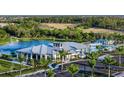 Community clubhouse with pool, fountain, and ample parking at 17778 Solstice Ave, Venice, FL 34293