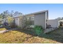 Gray house exterior with a small yard and white fence at 2044 Sheffield Ct, Oldsmar, FL 34677