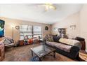 Spacious living room with a gray couch and glass coffee table at 2044 Sheffield Ct, Oldsmar, FL 34677