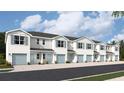 Two-story townhouses with light blue accents and attached garages at 4584 Stargazer Ct, Palm Harbor, FL 34683