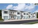 Five-unit townhome building with light blue accents and attached garages at 4588 Stargazer Ct, Palm Harbor, FL 34683