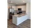 Modern kitchen with stainless steel appliances, white cabinets, and granite countertops at 4592 Pleasant Ave, Palm Harbor, FL 34683