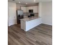 Modern kitchen featuring stainless steel appliances, white cabinets, and a center island at 4604 Pleasant Ave, Palm Harbor, FL 34683