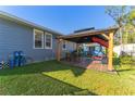 Cozy backyard gazebo, perfect for outdoor dining and relaxation, in a well-maintained yard at 702 E Gilchrist St, Plant City, FL 33563