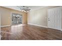Bright living room with wood-look floors and sliding glass doors at 10800 Us 19 N. # 230, Pinellas Park, FL 33782