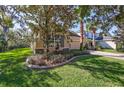 One-story house with gray shutters and manicured lawn at 11519 Coventry Grove Circle, Lithia, FL 33547