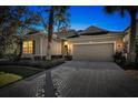 Attractive one-story home with well-lit exterior at dusk at 11519 Coventry Grove Circle, Lithia, FL 33547