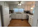 Bright kitchen featuring white appliances, ample cabinetry, and a large window at 13225 101St St # 451, Largo, FL 33773