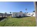 View of the backyard with a grassy area at 13995 Island Dr, Madeira Beach, FL 33708