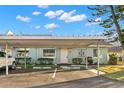 Charming light blue home with a carport and well-maintained landscaping at 2232 Greenwich Dr # 56, Sun City Center, FL 33573
