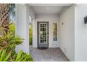 Inviting entryway with a gray door and brick walkway at 3132 Nautical S Pl, St Petersburg, FL 33712