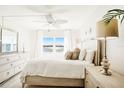 Inviting bedroom with a water view window, bright natural light, and a soft, calming color palette at 5020 Brittany S Dr # 213, St Petersburg, FL 33715