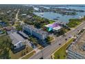 Aerial view showing condo building near waterfront, highlighting its convenient location at 55 Harbor View Ln # 301, Belleair Bluffs, FL 33770