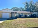 One-story home with attached garage, manicured lawn, and colorful decorations at 712 Gateway Ln, Tampa, FL 33613