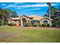 House exterior showcasing tile roof and lush lawn at 9336 Tooke Shore Dr, Weeki Wachee, FL 34613