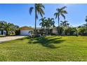 Single-story home with lush landscaping and a large yard at 936 79Th S St, St Petersburg, FL 33707