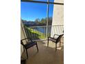 Relaxing balcony with wicker chairs overlooking a tranquil waterway at 948 Virginia St # 207, Dunedin, FL 34698