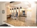 Bright kitchen with granite countertops, sleek appliances, and a breakfast bar at 1506 Bentwood Dr, Sun City Center, FL 33573