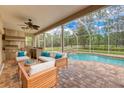 Relaxing patio with outdoor seating and a view of the pool at 16004 Shinnecock Dr, Odessa, FL 33556